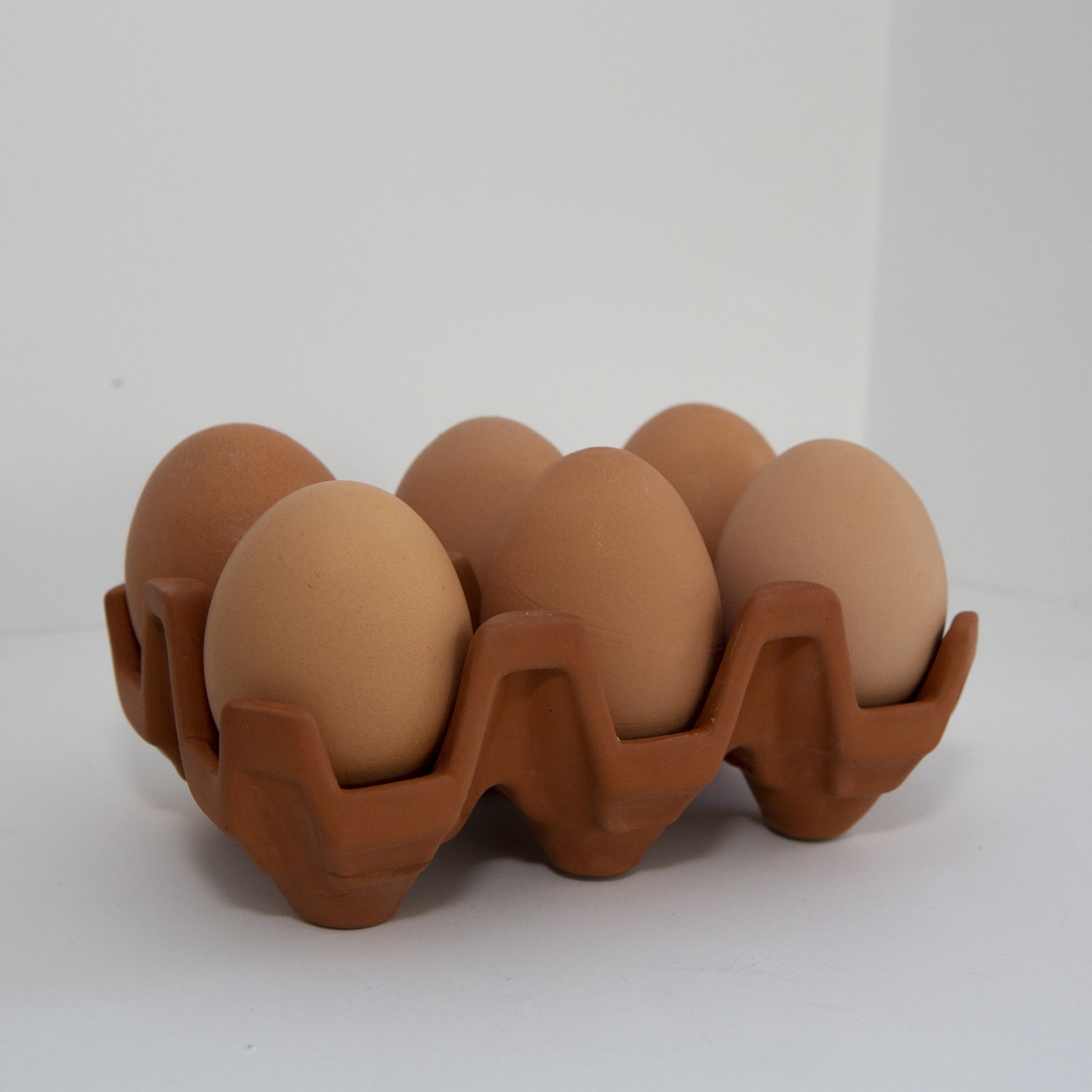 Terracotta egg racks are an ideal way to store your eggs .Designed from the traditional cardboard trays. Holds 6 eggs 
Designer: KDT 
Product Measurement: 5.5